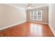 Bedroom with hardwood flooring, base trim and a large window for ample natural light at 109 Aisling Ct, Cary, NC 27513