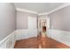 Dining area with hardwood floors, neutral paint, and an open doorway to another room at 109 Aisling Ct, Cary, NC 27513
