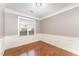 Bright dining room featuring hardwood floors, window views, and elegant wainscoting at 109 Aisling Ct, Cary, NC 27513