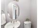 Powder room features a pedestal sink, oval mirror, and decorative accents at 109 Aisling Ct, Cary, NC 27513