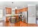 Gourmet kitchen with stainless steel appliances, granite countertops, and a central island at 109 Aisling Ct, Cary, NC 27513