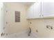 Well lit laundry room featuring white cabinets and washer/dryer hookups at 109 Aisling Ct, Cary, NC 27513