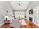 Spacious living room with a fireplace, hardwood floors, high ceilings, and ample natural light at 109 Aisling Ct, Cary, NC 27513
