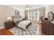 Stylishly decorated main bedroom featuring a ceiling fan, area rug and ample natural light at 109 Aisling Ct, Cary, NC 27513