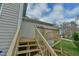 Back deck with wooden stairs and railing providing access to the backyard, great for relaxing at 110 Sudbury Ln, Chapel Hill, NC 27516