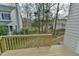View of the backyard from the wooden deck, showcasing a spacious grassy area and privacy at 110 Sudbury Ln, Chapel Hill, NC 27516