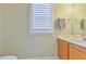 Bathroom featuring a wooden vanity with sink, and a window with plantation shutters at 110 Sudbury Ln, Chapel Hill, NC 27516