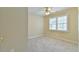 Cozy bedroom with neutral carpet, a ceiling fan and natural light from a window at 110 Sudbury Ln, Chapel Hill, NC 27516