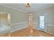 Dining area featuring hardwood floors, wainscoting and a door leading outside at 110 Sudbury Ln, Chapel Hill, NC 27516