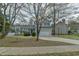Traditional two-story home with light gray siding, blue shutters, and a spacious two-car garage at 110 Sudbury Ln, Chapel Hill, NC 27516
