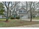 Charming two-story home featuring light gray siding, a blue front door, and a two-car garage at 110 Sudbury Ln, Chapel Hill, NC 27516