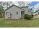 Side view of a cozy home with a well-maintained lawn and small covered porch at 110 Sudbury Ln, Chapel Hill, NC 27516