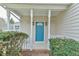 Charming front porch with a vibrant blue door and classic white columns, and well-manicured bushes at 110 Sudbury Ln, Chapel Hill, NC 27516