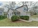 Charming two-story home boasts a well-manicured front yard, blue door, and attached garage at 110 Sudbury Ln, Chapel Hill, NC 27516