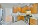 Bright kitchen featuring stainless steel appliances, granite countertops, and a tiled floor at 110 Sudbury Ln, Chapel Hill, NC 27516