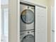 Efficient laundry closet featuring a stacked washer and dryer unit at 110 Sudbury Ln, Chapel Hill, NC 27516