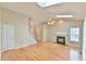Bright living room featuring a fireplace, hardwood floors, skylights and ceiling fan at 110 Sudbury Ln, Chapel Hill, NC 27516