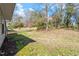 Spacious backyard with mature trees, lawn, and a partial view of the home at 113 Duchess Ln, Chapel Hill, NC 27517