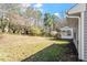 Spacious backyard with mature trees and a partial view of a screened-in porch at 113 Duchess Ln, Chapel Hill, NC 27517