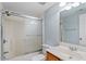 Bright bathroom with a single sink vanity and a shower over tub with sliding glass doors at 113 Duchess Ln, Chapel Hill, NC 27517