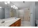 Well-lit bathroom featuring a double sink vanity and shower with sliding glass doors at 113 Duchess Ln, Chapel Hill, NC 27517