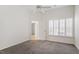 Spacious bedroom with carpet, ceiling fan, a window with blinds, and ensuite bathroom entrance at 113 Duchess Ln, Chapel Hill, NC 27517
