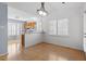 Bright dining room with hardwood floors, modern light fixture, and large windows with shutters at 113 Duchess Ln, Chapel Hill, NC 27517