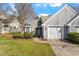 Charming home with a two-car garage, well-manicured lawn, and mature landscaping creates inviting curb appeal at 113 Duchess Ln, Chapel Hill, NC 27517