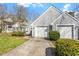 Charming home with a two-car garage, well-manicured lawn, and mature landscaping creates inviting curb appeal at 113 Duchess Ln, Chapel Hill, NC 27517