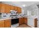 Kitchen features wood cabinets, white countertops, tile backsplash, and stainless steel appliances at 113 Duchess Ln, Chapel Hill, NC 27517