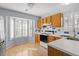 Charming kitchen features wood cabinets, white countertops, tile backsplash, and a bright breakfast nook at 113 Duchess Ln, Chapel Hill, NC 27517
