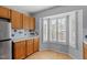Bright kitchen featuring wood cabinets, white countertops, tile backsplash, and stainless steel refrigerator at 113 Duchess Ln, Chapel Hill, NC 27517