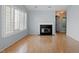 Bright living room boasts a fireplace, recessed lighting, and large windows with plantation shutters at 113 Duchess Ln, Chapel Hill, NC 27517