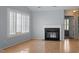 Bright living room boasts a fireplace, recessed lighting, and large windows with plantation shutters at 113 Duchess Ln, Chapel Hill, NC 27517