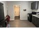 Functional kitchen with black appliances, neutral grey cabinets, and modern flooring at 113 Warren Ave, Oxford, NC 27565