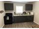 Well-lit kitchen with stainless steel sink, gray cabinets, and modern amenities at 113 Warren Ave, Oxford, NC 27565