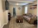 Cozy living room with wood-look floors, neutral paint, and comfortable furnishings at 113 Warren Ave, Oxford, NC 27565