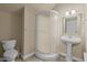 Cozy bathroom showcasing a pedestal sink and unique corner shower with a textured glass door at 1203 Fairview Club Dr, Wake Forest, NC 27587