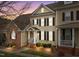 Charming two-story home features a classic design with black shutters and a welcoming front porch at 1203 Fairview Club Dr, Wake Forest, NC 27587