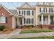 Charming home exterior with tan siding, black shutters, and a welcoming front porch at 1203 Fairview Club Dr, Wake Forest, NC 27587
