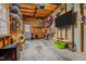 Well-organized garage with exposed wood beams, a TV, and ample storage and workspace at 1203 Fairview Club Dr, Wake Forest, NC 27587