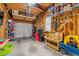 Spacious garage with concrete floors, overhead storage, and door leading to outside at 1203 Fairview Club Dr, Wake Forest, NC 27587