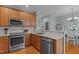 Modern kitchen with stainless steel appliances, granite countertops, and ample cabinet space at 1203 Fairview Club Dr, Wake Forest, NC 27587