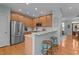 Bright kitchen with stainless steel appliances, light wood cabinets, and granite countertops at 1203 Fairview Club Dr, Wake Forest, NC 27587