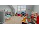 Spacious playroom with large windows, and a variety of toys and play equipment at 1203 Fairview Club Dr, Wake Forest, NC 27587