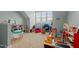 Spacious playroom with carpet floors, natural light, and variety of fun toys at 1203 Fairview Club Dr, Wake Forest, NC 27587