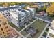 Aerial view showcasing modern townhomes with landscaped common areas and inviting outdoor spaces, perfect for community living at 1230 Coach Station Alley # 101, Raleigh, NC 27601