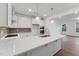 Modern kitchen with stainless appliances, island, and sleek white cabinets at 1230 Coach Station Alley # 101, Raleigh, NC 27601