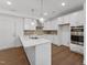 Modern kitchen with ample counter space, stainless appliances, and wood floors at 1230 Coach Station Alley # 101, Raleigh, NC 27601