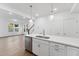 Open kitchen featuring an island, stainless steel dishwasher, and adjacent staircase at 1230 Coach Station Alley # 101, Raleigh, NC 27601